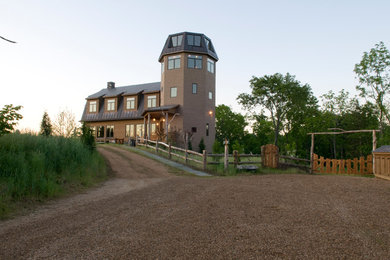 Huge rustic brown three-story wood exterior home idea in Other
