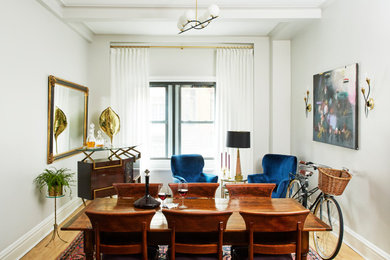 Dining room - mid-sized eclectic medium tone wood floor dining room idea in New York with blue walls