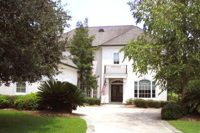 Mid-sized elegant white two-story stucco exterior home photo in New Orleans