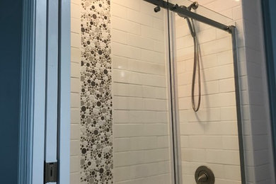 Example of a small beach style master white tile and ceramic tile vinyl floor and gray floor bathroom design in Other with furniture-like cabinets, white cabinets, a two-piece toilet, gray walls, an undermount sink, granite countertops and gray countertops
