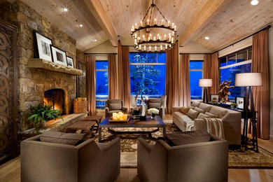 Photo of a large traditional enclosed living room in Salt Lake City with beige walls, light hardwood floors, a standard fireplace, a stone fireplace surround, no tv and beige floor.