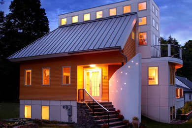Mid-sized minimalist multicolored two-story mixed siding house exterior photo in Boston with a hip roof and a metal roof