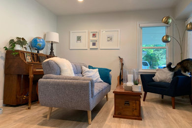 Inspiration for a scandinavian open concept light wood floor living room remodel in Minneapolis with white walls