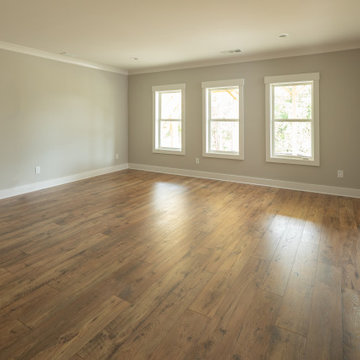 Secondary Bedroom with Hardwood Floors and Triple Window