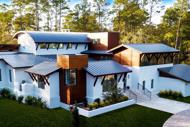 Example of a mid-sized trendy wood house exterior design in Other
