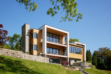 Mid-sized multicolored three-story wood and shingle exterior home idea in New York