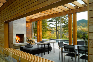 Pool house - large modern backyard stone and rectangular lap pool house idea in Burlington