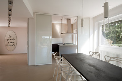 Photo of a contemporary dining room in Rome with white walls and porcelain floors.
