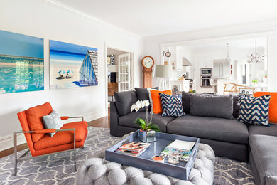 Inspiration for a large transitional enclosed medium tone wood floor living room remodel in New York with white walls