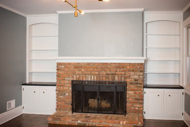 Mid-sized elegant enclosed dark wood floor living room photo in New York with gray walls, a standard fireplace, a brick fireplace and no tv