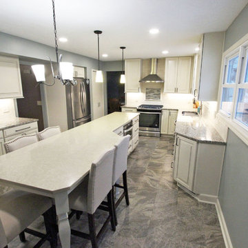 Beige Kitchen with Extra Large Island, Tile Backsplash and Granite Countertops