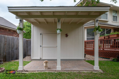 Example of a mid-sized classic backyard concrete paver patio design in Austin with a roof extension