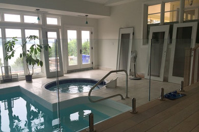 Example of a mid-sized classic courtyard stone and custom-shaped pool house design in Montreal