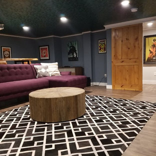 Design ideas for a large contemporary enclosed home cinema in Boston with blue walls, laminate floors and a projector screen.