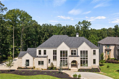 Example of a large classic beige shingle house exterior design in Atlanta with a shingle roof and a gray roof