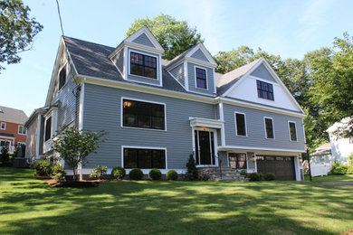 Mid-sized transitional split-level grey house exterior in Boston with concrete fiberboard siding, a gable roof, a shingle roof, a black roof and clapboard siding.