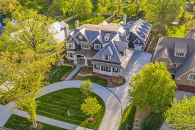 Inspiration for a huge country blue three-story wood and shingle exterior home remodel in Chicago with a shingle roof and a brown roof