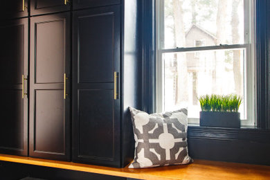 Example of a mid-sized transitional porcelain tile and white floor entryway design in Boston with black walls and a black front door