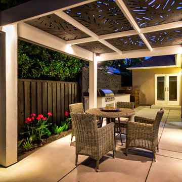 Warm Evening Glow Facing the House: Pergola, Dining, and Outdoor Kitchen