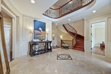 Example of a huge classic marble floor, beige floor, coffered ceiling and wallpaper entryway design in Chicago with beige walls and a dark wood front door