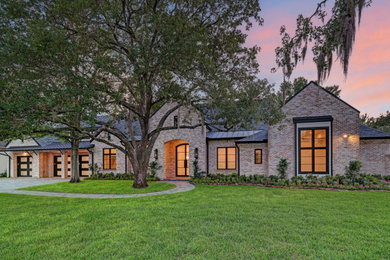 Transitional one-story house exterior idea in Houston with a mixed material roof and a black roof