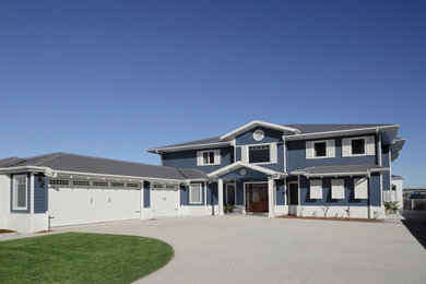 Huge coastal blue two-story concrete fiberboard house exterior idea in Sunshine Coast with a hip roof and a tile roof