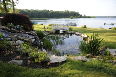 This is an example of a large rustic partial sun backyard mulch landscaping in New York.