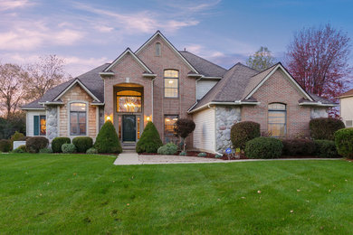 Transitional multicolored two-story mixed siding house exterior photo in Detroit with a hip roof and a shingle roof