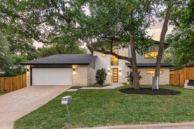 Example of a mid-sized trendy multicolored two-story mixed siding exterior home design in Austin with a shingle roof