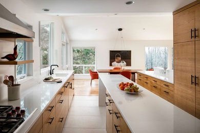 Example of a large mid-century modern galley porcelain tile and gray floor eat-in kitchen design in Portland with an undermount sink, flat-panel cabinets, medium tone wood cabinets, quartzite countertops, white backsplash, stone slab backsplash, an island, white countertops and paneled appliances