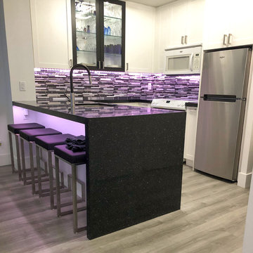 Custom shaker-style kitchen with waterfall countertop in Toronto