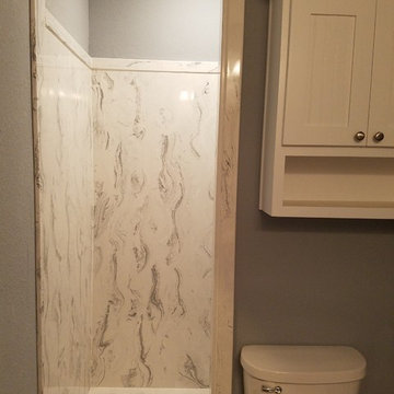 Cultured Marble walk-in shower in master. Extra cabinets above comfort-height c