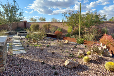 Design ideas for a mid-sized modern drought-tolerant, desert and full sun backyard concrete paver landscaping in Milwaukee for summer.