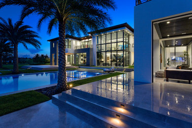 Example of a huge white two-story stucco house exterior design in Miami with a hip roof and a tile roof