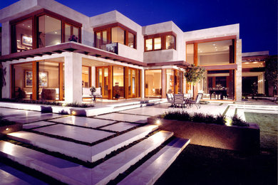 Large contemporary white two-story flat roof idea in Orange County