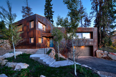 Photo of a modern two-storey brown house exterior in Salt Lake City with metal siding.