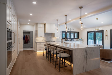 Large open concept kitchen photo in DC Metro with shaker cabinets, white cabinets and an island