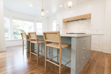 Inspiration for a huge transitional l-shaped dark wood floor and shiplap ceiling open concept kitchen remodel in San Francisco with a farmhouse sink, recessed-panel cabinets, blue cabinets, gray backsplash, an island and gray countertops