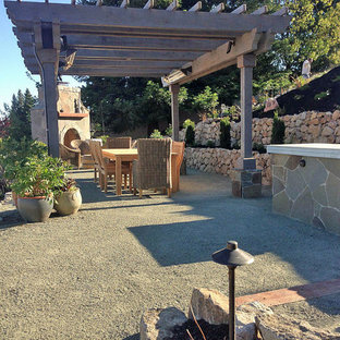 This is an example of an expansive traditional backyard patio in San Francisco with a fire feature, decomposed granite and a pergola.