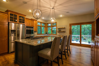 Eat-in kitchen - large contemporary medium tone wood floor and brown floor eat-in kitchen idea in Other with a double-bowl sink, flat-panel cabinets, blue cabinets, granite countertops, gray backsplash, porcelain backsplash, stainless steel appliances and an island