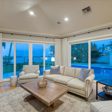 Traditional Waterfront Living Room Framed by Expansive Glass and Timeless Coasta