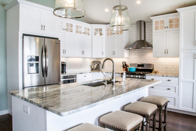 Example of a large classic l-shaped dark wood floor kitchen design in Birmingham with an undermount sink, recessed-panel cabinets, white cabinets, granite countertops, white backsplash, subway tile backsplash, stainless steel appliances and an island