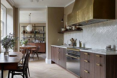 Inspiration for a medium sized contemporary single-wall open plan kitchen in London with a submerged sink, flat-panel cabinets, dark wood cabinets, marble worktops, white splashback, ceramic splashback, black appliances, light hardwood flooring, no island, white worktops and a drop ceiling.