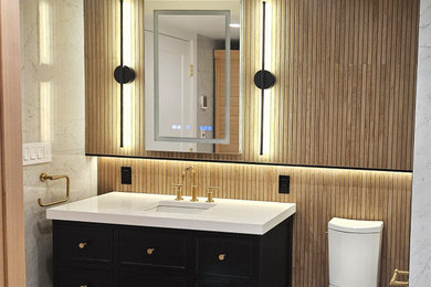 Example of a mid-sized minimalist gray tile and porcelain tile porcelain tile, gray floor and single-sink bathroom design in New York with shaker cabinets, black cabinets, a two-piece toilet, gray walls, an undermount sink, quartz countertops, a hinged shower door, white countertops and a floating vanity