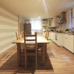 Inspiration for a large country walk-out basement in Milan with multi-coloured walls, painted wood flooring, a standard fireplace, a concrete fireplace surround and brown floors.