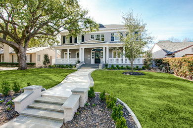 Example of a large classic gray two-story brick house exterior design in Dallas with a hip roof and a shingle roof