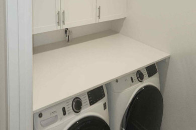 Dedicated laundry room - small contemporary dedicated laundry room idea in San Diego with shaker cabinets, a side-by-side washer/dryer and white countertops
