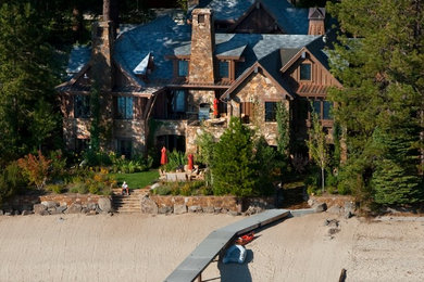 Example of a huge classic brown three-story stone exterior home design in Other