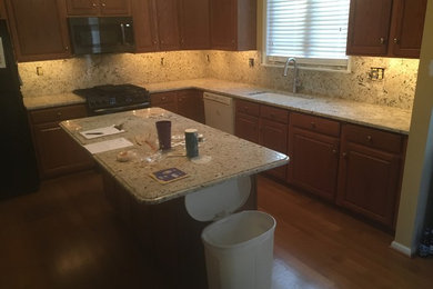 New Snowfall Granite Countertops and Fullheight Backsplash
