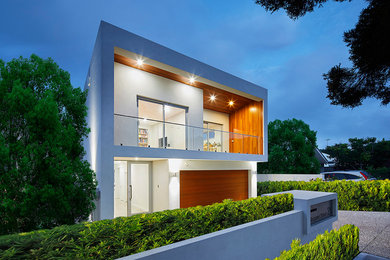 This is an example of a small modern two-storey white house exterior in Perth with wood siding.